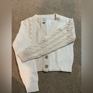 Have cream and white sweater